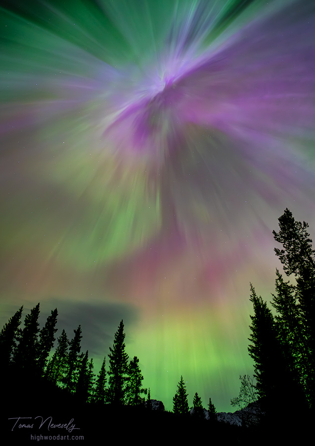 Mesmerizing aurora borealis over snowy mountains, Kananaskis, Alberta, Canada