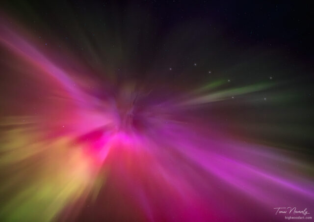 Mesmerizing aurora borealis over snowy mountains, Kananaskis, Alberta, Canada
