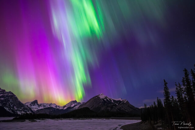 Mesmerizing aurora borealis over snowy mountains, Kananaskis, Alberta, Canada